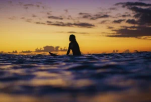 the-cove-at-cerritos-surfer-girl-catching-waves-in-the-ocean-swimming-deep - -